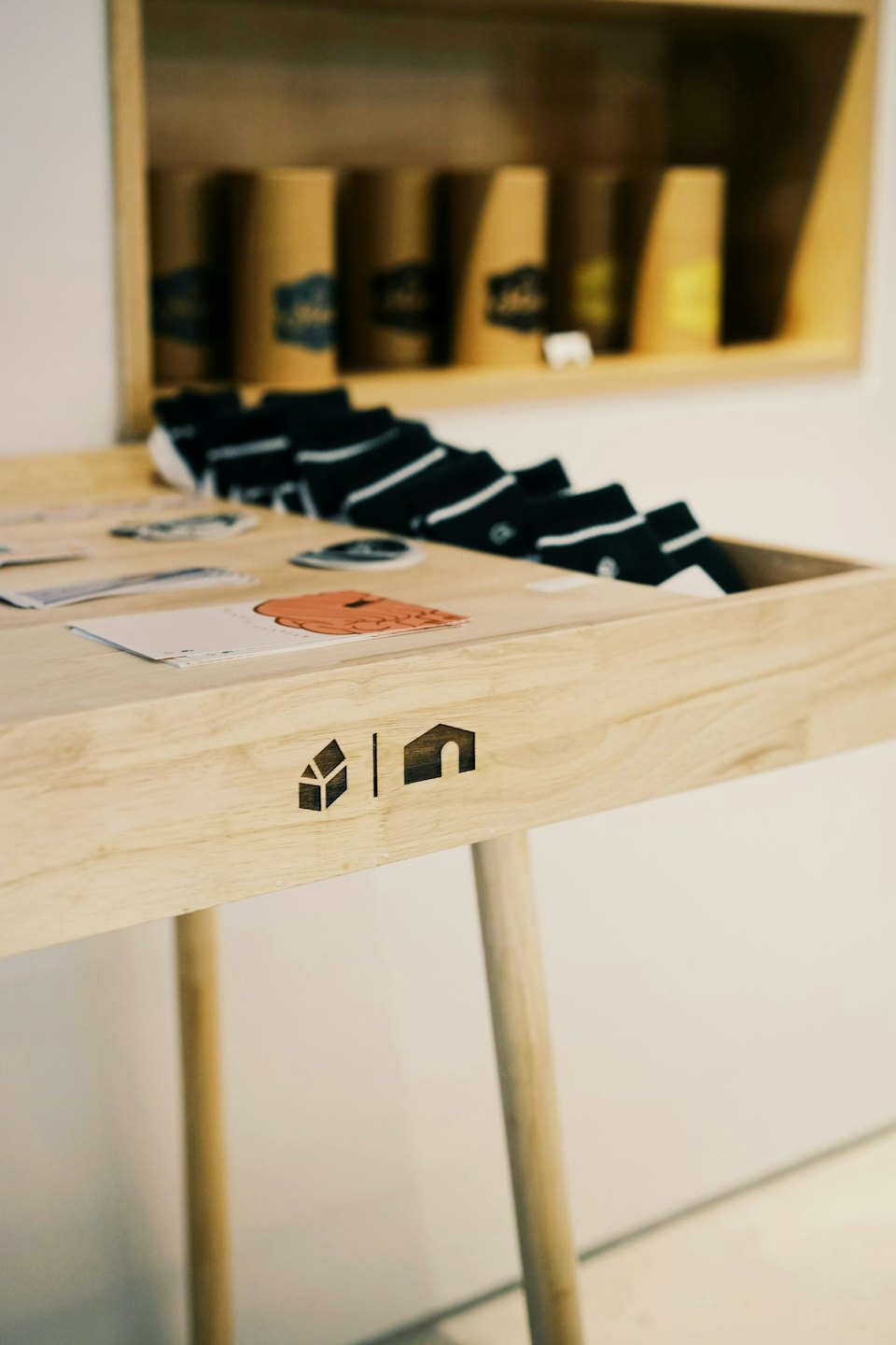 Striped socks and cards displayed on a wooden retail table.